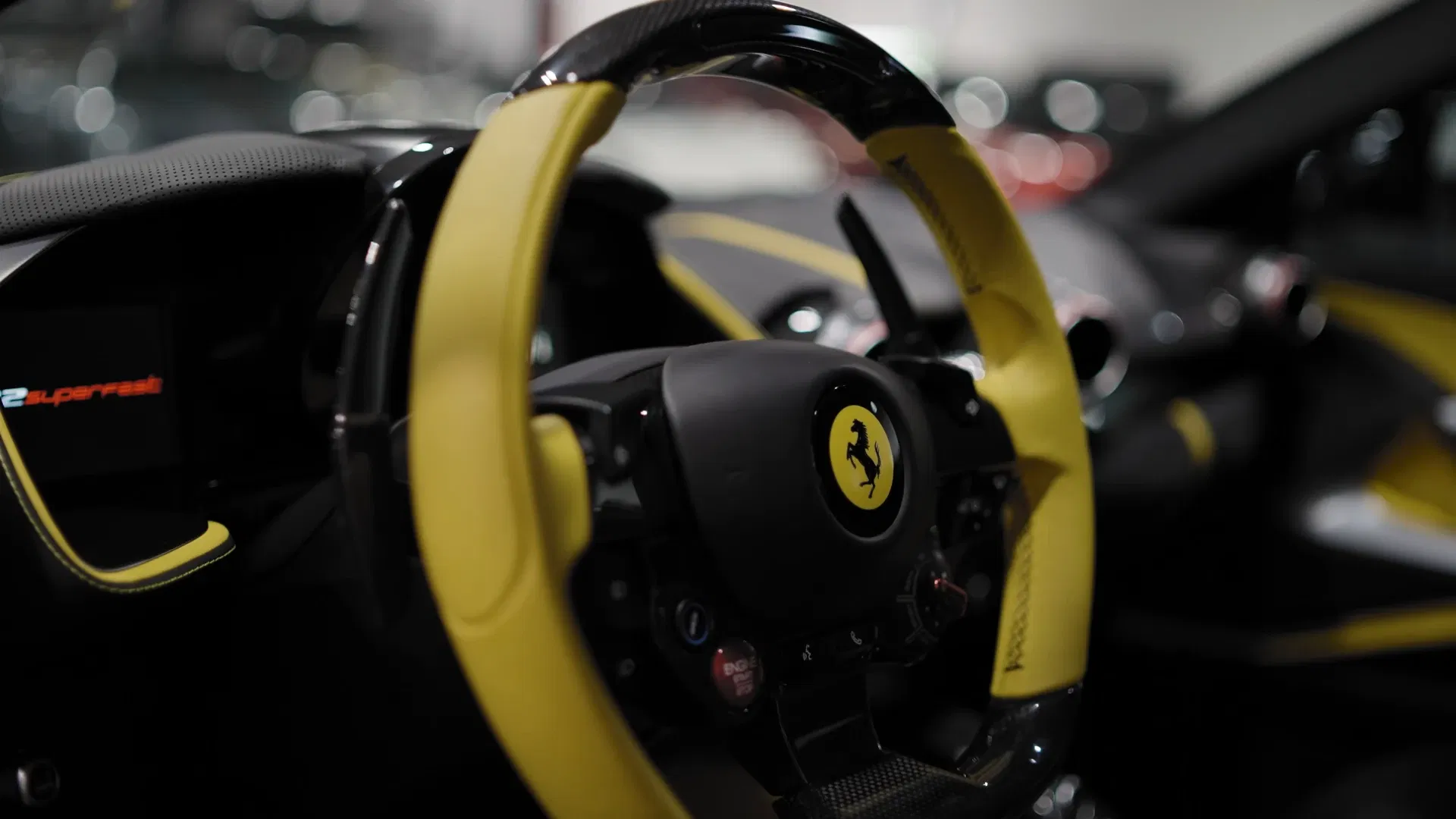 Tactical Fleet film detail framing the Ferrari steering wheel and interior materials