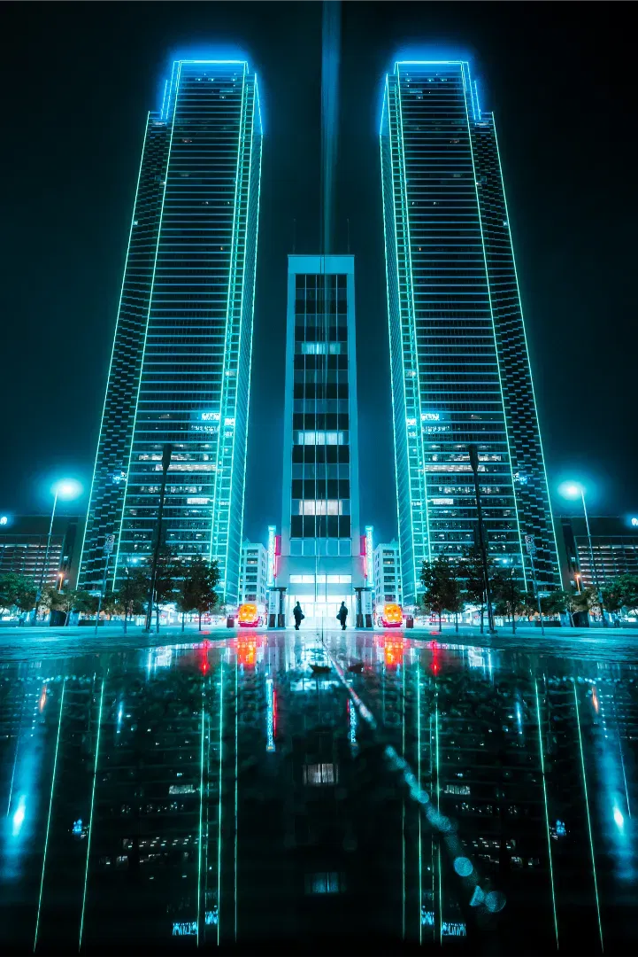 A symmetrical, cyberpunk-inspired view of a futuristic neon-outlined skyscraper complex at night, reflecting in a smooth water basin.