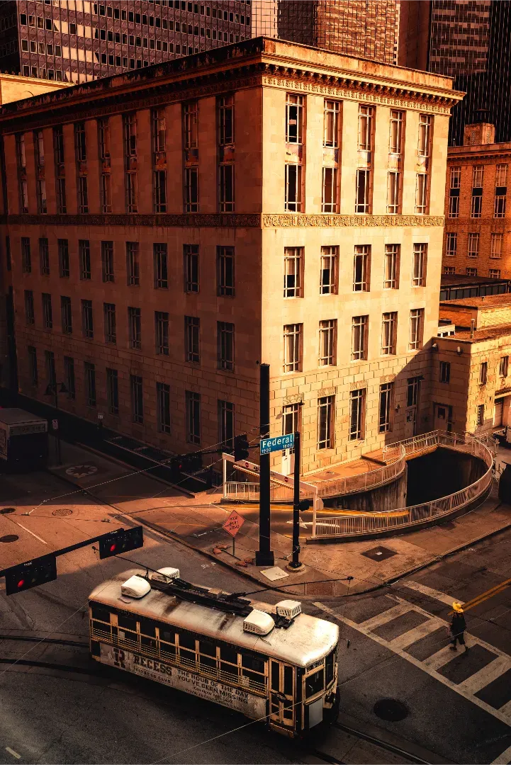 A high-angle view of the McKinney Avenue streetcar at golden hour in Dallas.